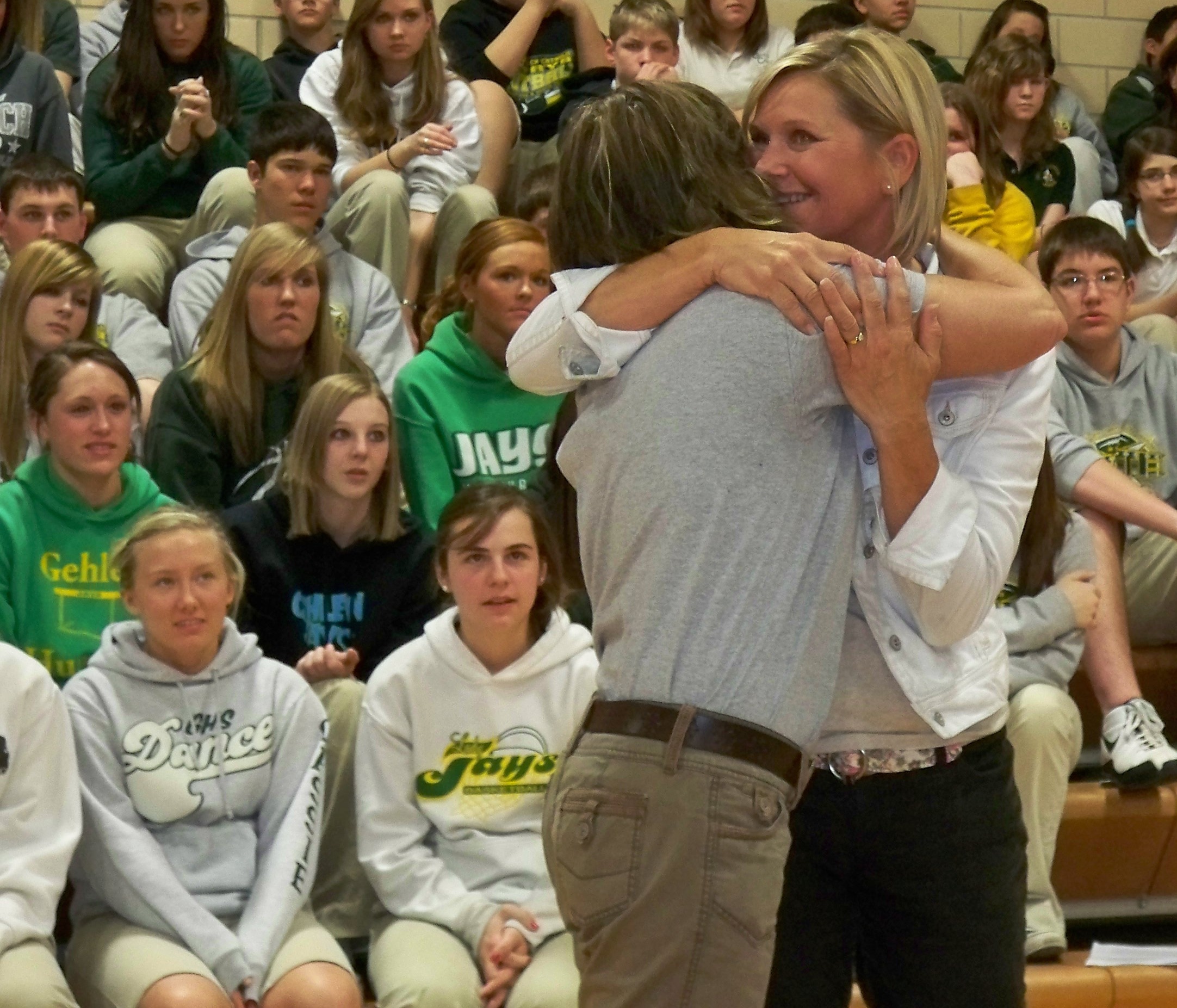 Linda Reichle receives a hug after being given her GCMH cross 
