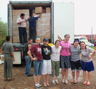 Heelan students help unload the containerof Then Feed Just One food that they helped to pack a month earlier