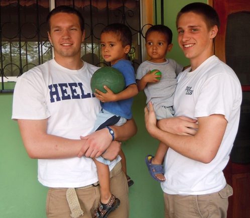 Zach Maxey & Pete Fitzsimmons hold 2 little boys at the malnutrition center in Sulaco