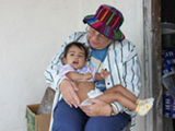Sr. Juanita holds child in Vallecillo