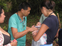 Dr. David Goo & Dr. Jessica Doyle examine baby on the mountain trail