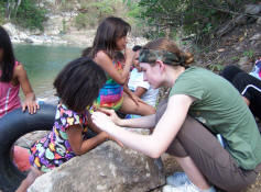 Stacie Duckwitz pins a 'You Are Loved' button on an orphan girl