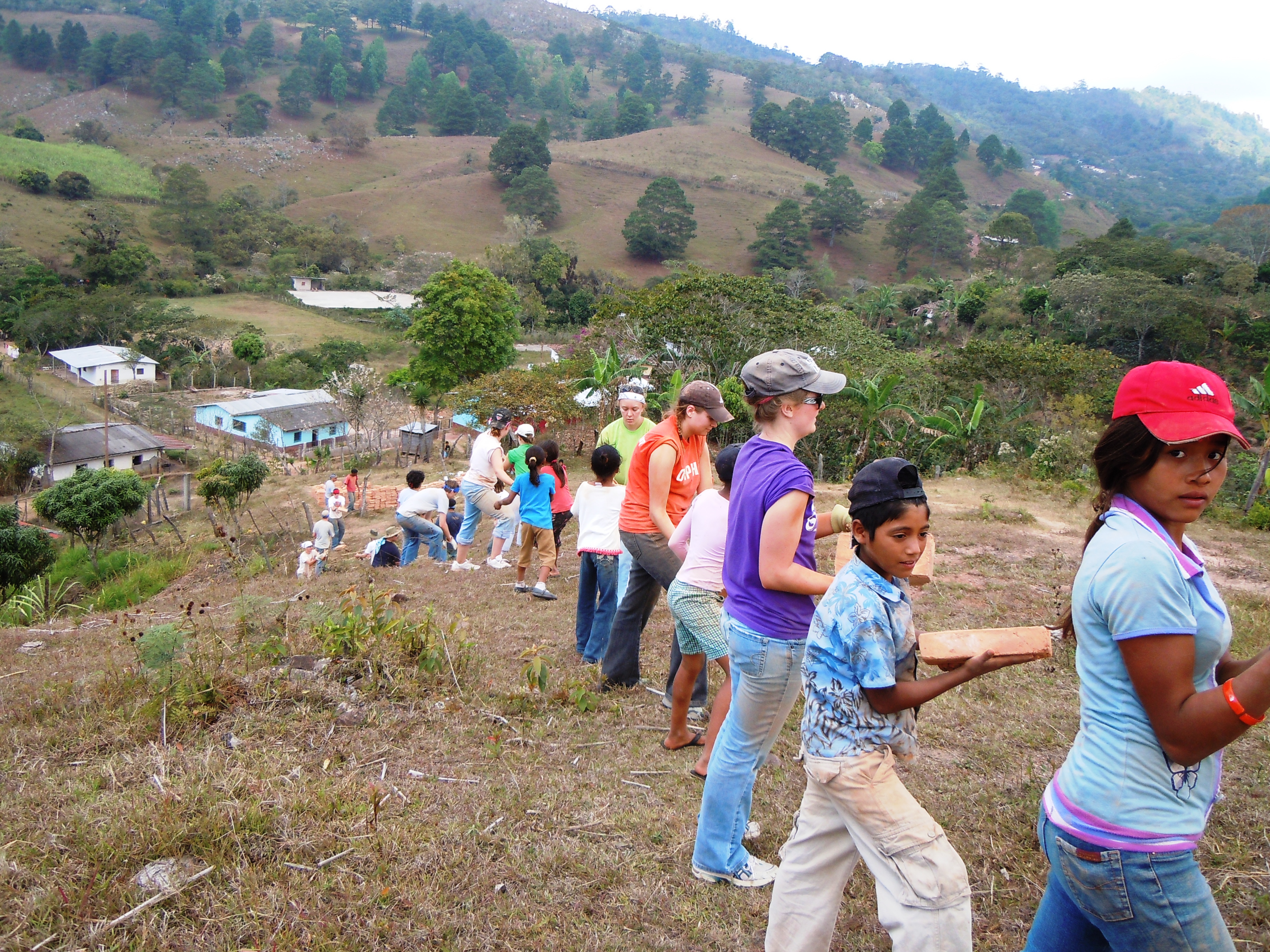 Group passes bricks up the mountain