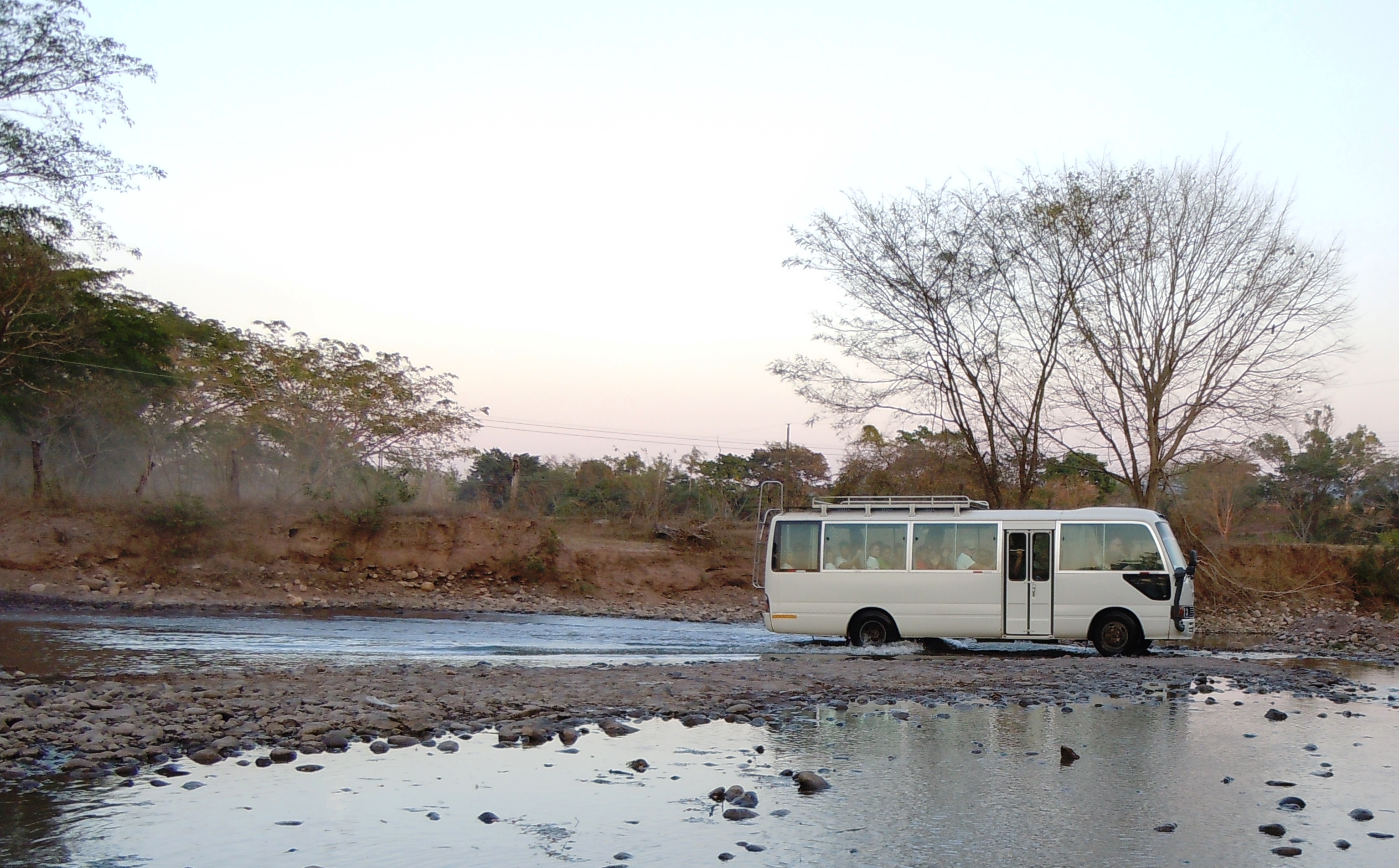 Missioners ride the bus on a typical road to Esquias