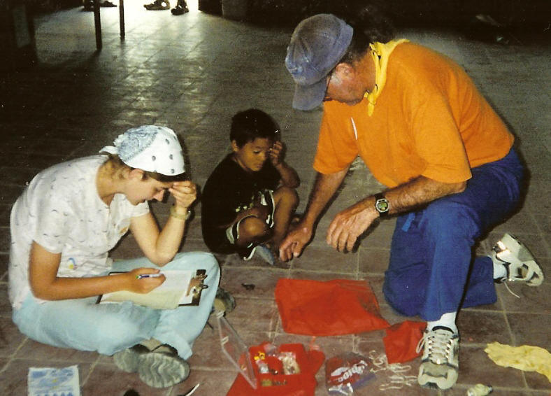 Catherine, Cristobal,  & Francis looking through supplies