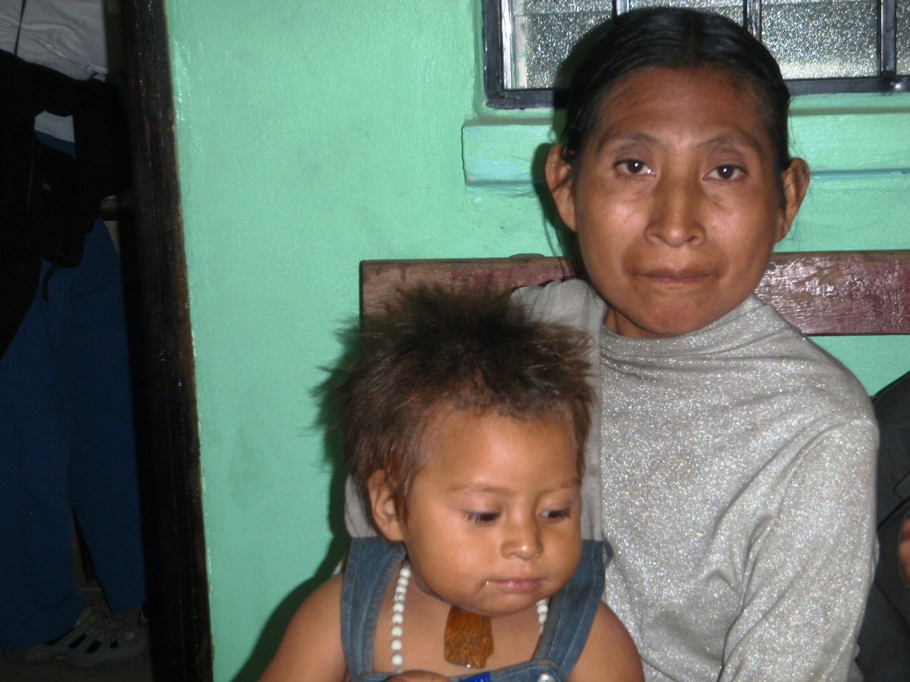 Mother and child wait to be examined by a medical team member