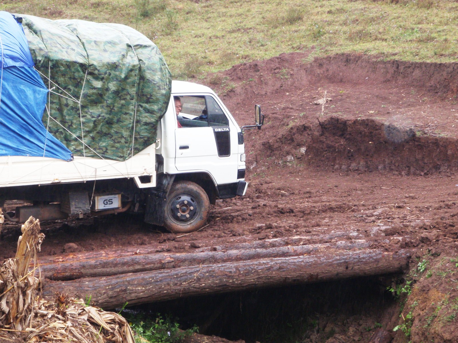 Medical team truck traverses a makeshift bridge enroute to Montana de la Flor