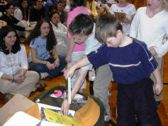 Students add Spanish books to the bags during the send-off