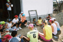 The team plays a game with the children during a break