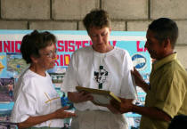 Carolyn Bickford gives her husband's photo to a clinic representative