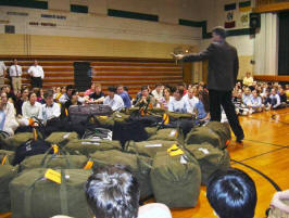 Fr. Kevin Richter blesses the bags & their contents at the send-off prayer service