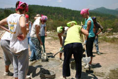 Students mix cement by hand