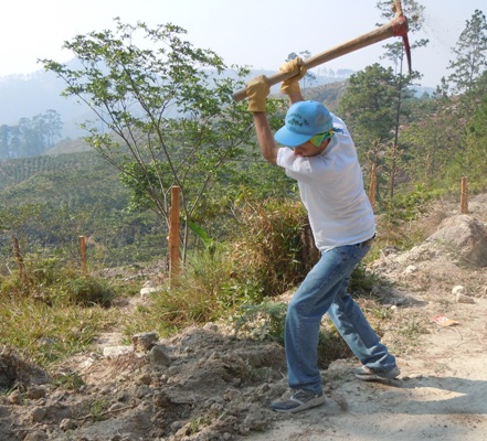 Sam Ahlers helps to dig trenches for water pipes