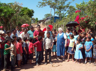 Angel, water project coordinator, reads the thank you plaque for the El Junco water project