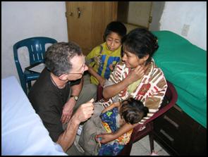 Herb Kuehne speaks with a woman at the medical clinic.